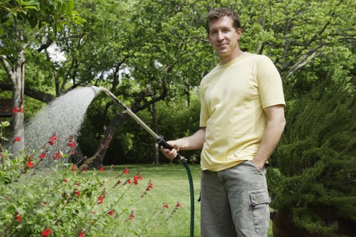 Professional gardener pruning shrubs in Penge